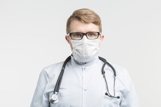 Health and medicine - doctor wearing the stethoscope and white mask on white background.