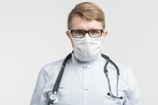 Health and medicine - doctor wearing the stethoscope and white mask on white background.