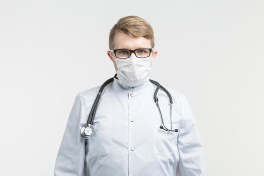 Health and medicine - doctor wearing the stethoscope and white mask on white background.