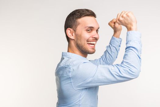 Cheerful young man posing on white background