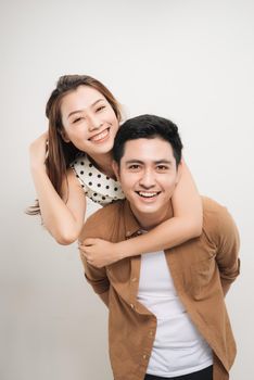 man carrying his lover on back, woman showing peace symbol over white background