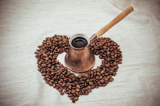 Coffee turk on burlap background. coffee beans isolated on white background. roasted coffee beans