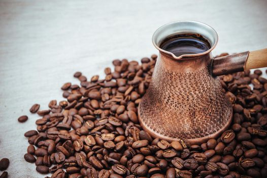 Coffee turk on burlap background. coffee beans isolated on white background. roasted coffee beans