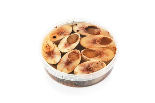 Salted herrings in a plastic pot isolated on the white background