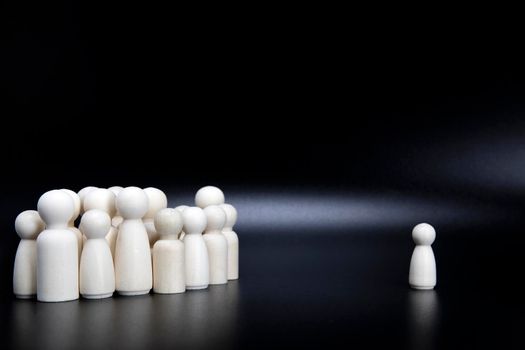 Uniqueness and independence. Dissidence. Stand out from crowd. Thought leader. Red wooden figure different from other black background copy space space for text