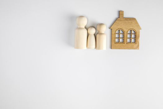Paper figures of family near house on white background. Happy family and home concept. Parents and children's with copy space space for background