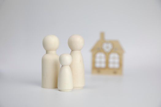 Paper figures of family near house on white background. Happy family and home concept. Parents and children's with copy space space for background