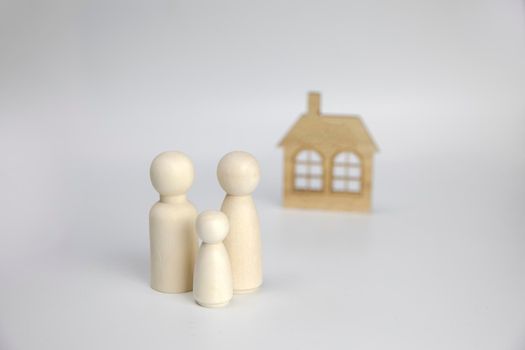 Paper figures of family near house on white background. Happy family and home concept. Parents and children's with copy space space for background