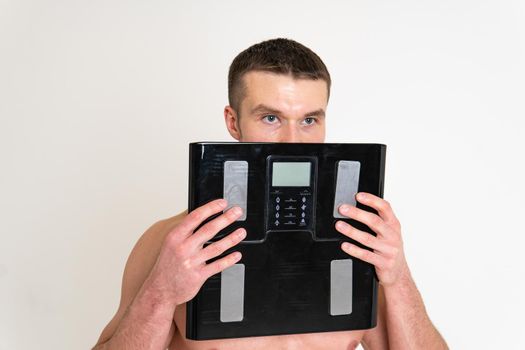 Man with weights health pondered, health and sports on a white background back sore painful, ill person male massage illness expression. Tension neck care, problem suffer attractive