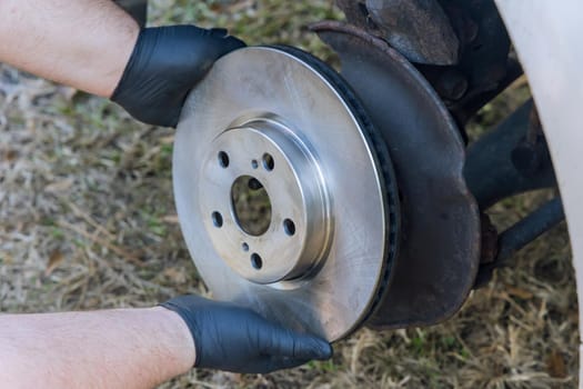 Car repair wheel hub of an old car brake pad, wheel axle, mounting new brake disc