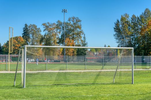 Empty football gate on blue sky background.