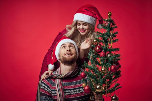 Cheerful young couple New Year in a place of Christmas holiday. High quality photo