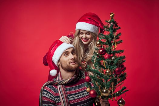 Cheerful young couple New Year in a place of Christmas holiday. High quality photo