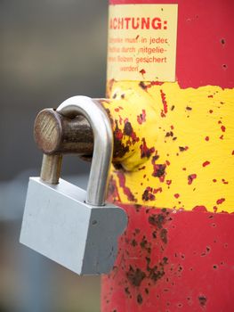 A bollard with a padlock attached.