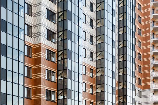 modern multi-family housing, residential building facade with aluminum windows.