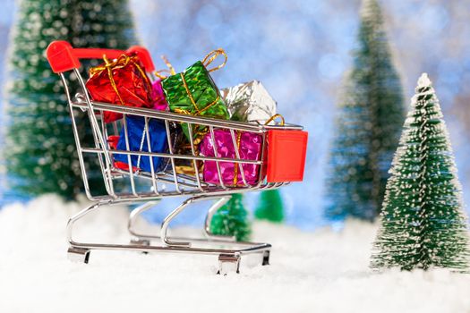Christmas shopping. Supermarket trolley with New Year's gifts. New year greeting card.