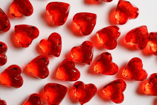 Directly Above Studio Full Frame Image of Sparkling Red Faux Gemstone Hearts on a White Studio Background.
