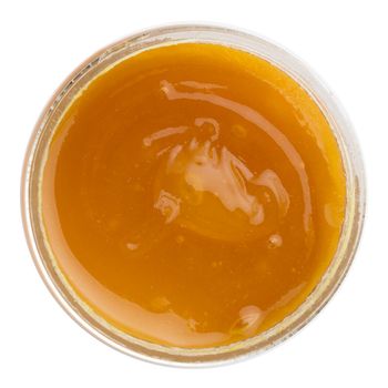 Top view of the jar of honey with propolis isolated on a white background. Top view.