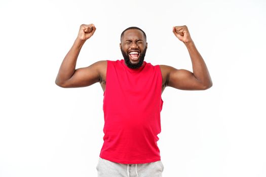 Young fitness african black man in sport wear cheering carefree and excited. Victory concept