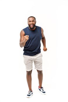 Young fitness african black man in sport wear cheering carefree and excited. Victory concept