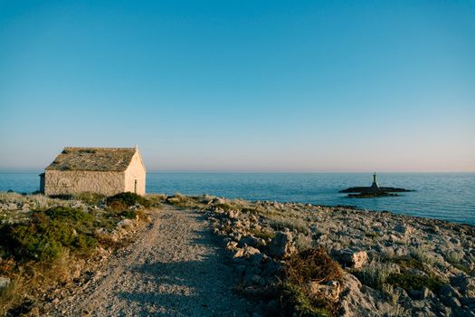 Country road to the old stone church of St. Ivan at cape Punta Planca. High quality photo