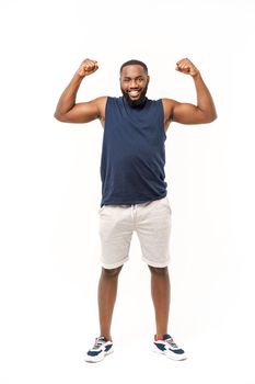 African American teenager shows muscles on arm. Isolated on white background. Studio portrait. Transitional age concept.
