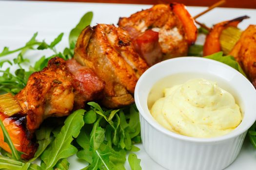 shish kebab on skewers with garlic sauce and lettuce