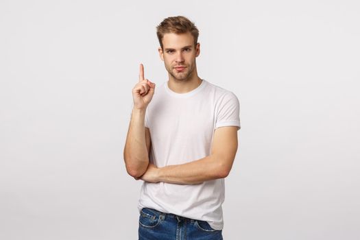 I got solution. Charming clever blond bearded male coworker have suggestion, raise index finger eureka gesture, smirk assertive and pleased with himself, standing self-assured white background.