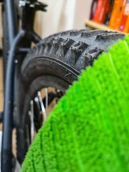 Green microfiber cloth lying on bicycle wheel