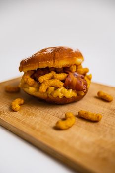 Dish for fat Thursday with big donut with mac and cheese bacon and peanut crisps