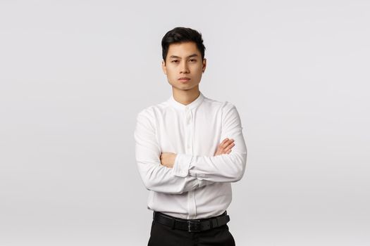 Corporate promo, recruitment and business concept. Attractive self-assured asian male entrepreneur, cross arms over chest, look camera focused and confident, able handle any task, solve problems.