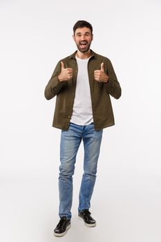 Full-length vertical studio shot cheerful good-looking bearded guy adores friends idea, show thumbs-up in like, approval or acceptance gesture, nod agreement, thinks plan awesome, white background.