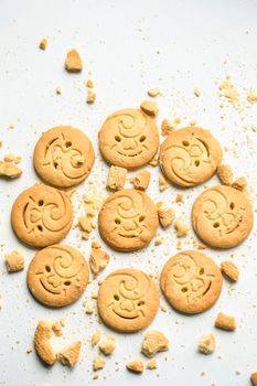 Sand cookies with a face and a smile.Small round cookies sprinkled with crumbs close up.