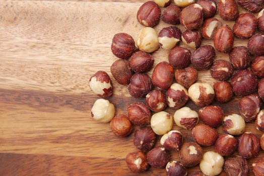 hazelnuts in a container on black background
