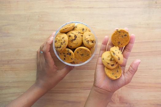 stack of chocolate cookies on wooden background.
