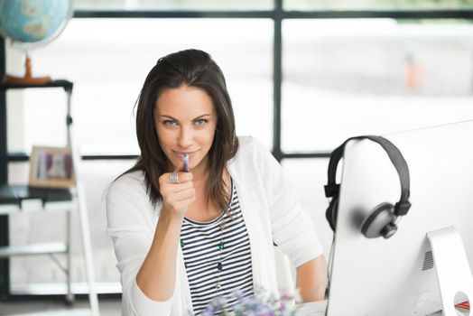 Attractive brunette woman at office desk work on computer