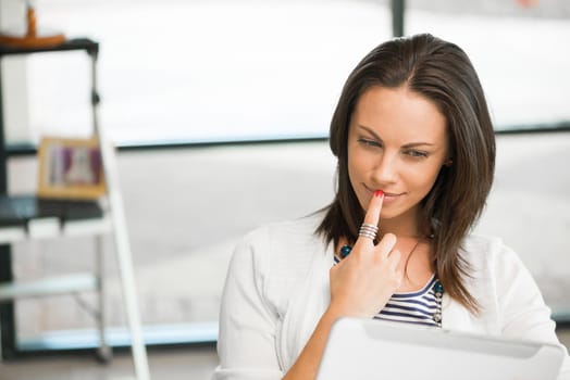 Young attractive brunette working with tablet pc