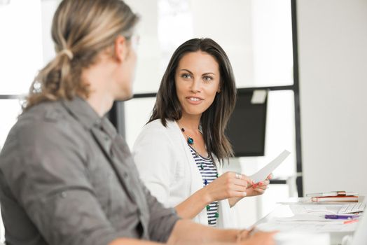 Young coworkers in office working together and discussing points