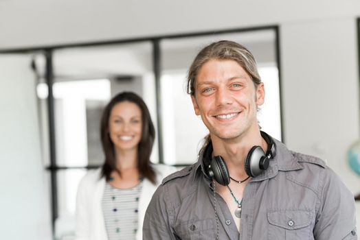 Portrait of young man and woman in bright office