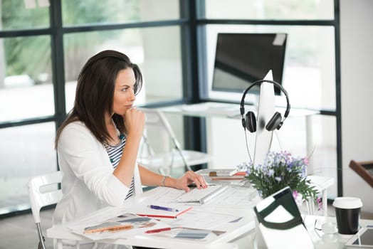 Attractive brunette woman at office desk work on computer