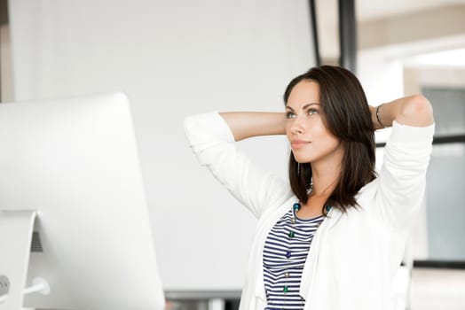 Attractive brunette woman at office desk work on computer