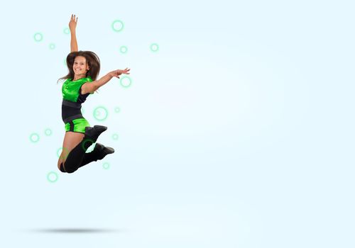 Young beautiful sporty cheerleader girl jumping high