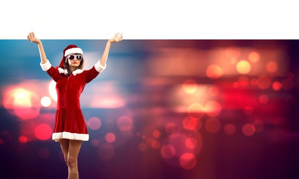 Attractive Santa woman with white blank banner. Place your text