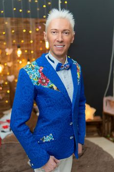 A man in a blue suit smiles with white hair suit blue studio person professional, from cut adult in job handsome manager, waist arms. Men serious front, commercial