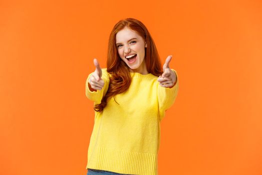 Excited, carefree cool modern hipster girl with red hair showing thumbs-up in approval, rooting for friend saying yeah, yes gesture, feeling upbeat and delighted, recommend product, fully-satisfied.