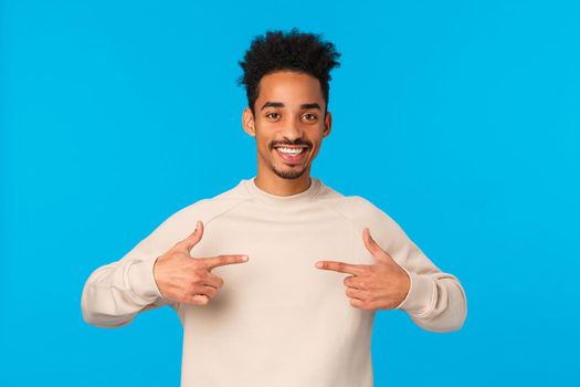I am the one. Cheerful and friendly confident lucky african american male with hipster afro haircut, pointing himself, want participate, volunteer, bragging or talking boastful personal achievement.