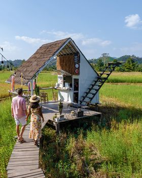 Nan Thailand December 2021, people visiting a coffee shop in the rice fields with white stair.