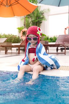 Little girl having fun in the pool. Summer holidays and vacation concept