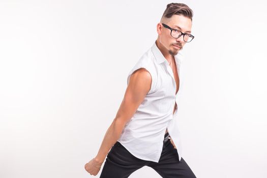 People, clothing and style concept - young handsome man posing in white shirt on white background.