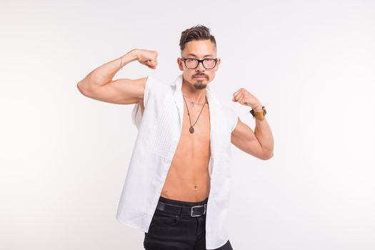 People, clothing and style concept - young handsome man posing in white shirt on white background.